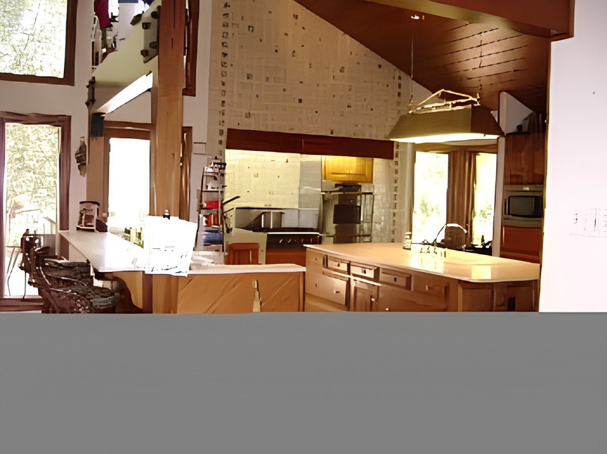 A spacious kitchen with wood accents and modern lighting.