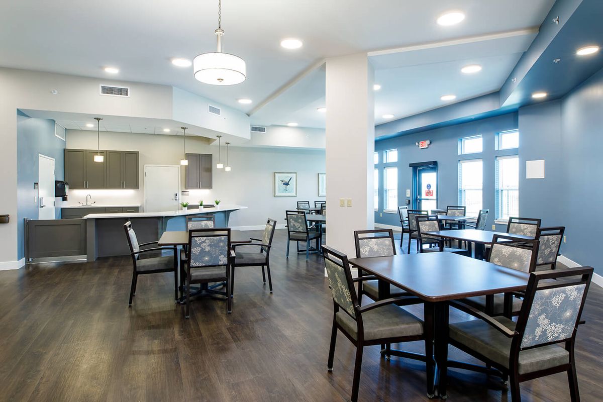 A modern and spacious dining area with sleek furniture and bright lighting.