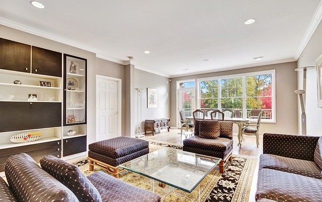 A well-lit living room with elegant decor and ample seating.
