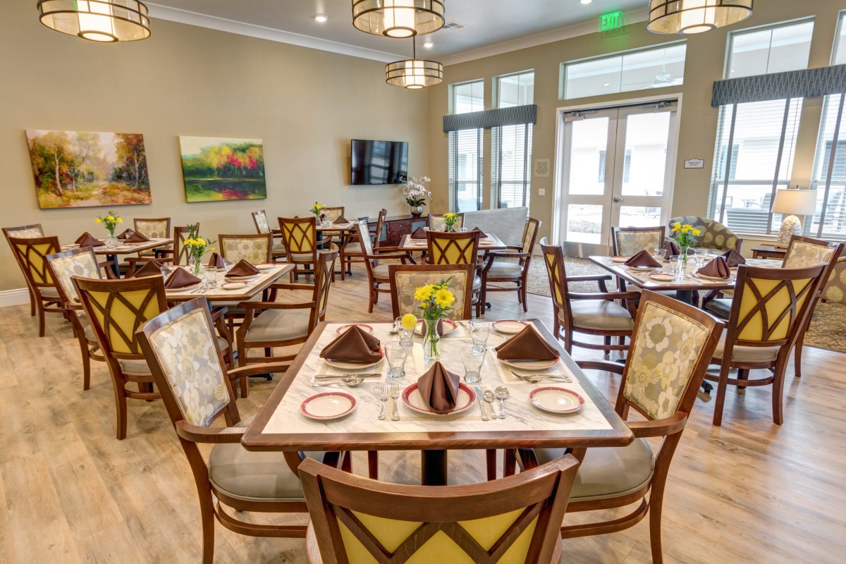 An elegantly decorated dining room with neatly arranged tables and chairs.