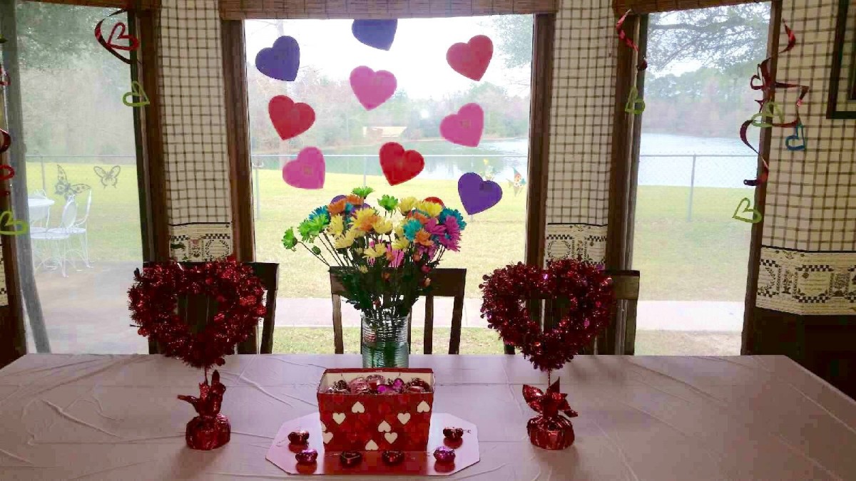 A festive Valentine's Day table setting with heart decorations and a colorful bouquet of flowers.
