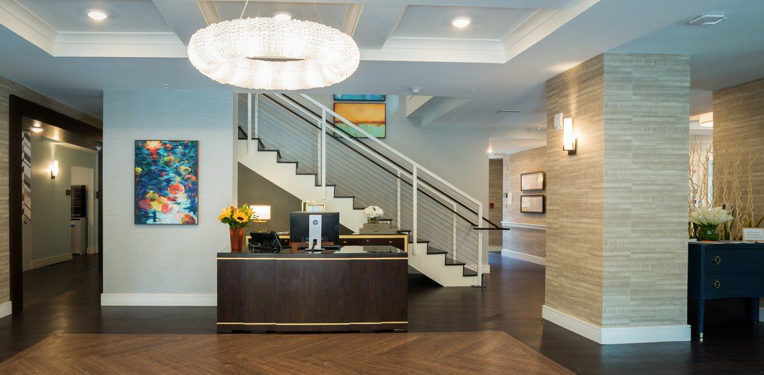 A modern office reception area with a staircase and elegant decor.