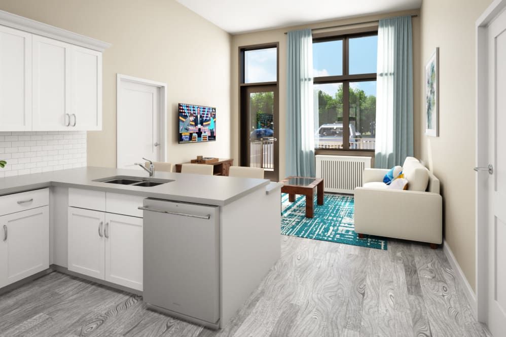 A modern open-concept apartment featuring a kitchen and living room area, with contemporary furniture and decor.