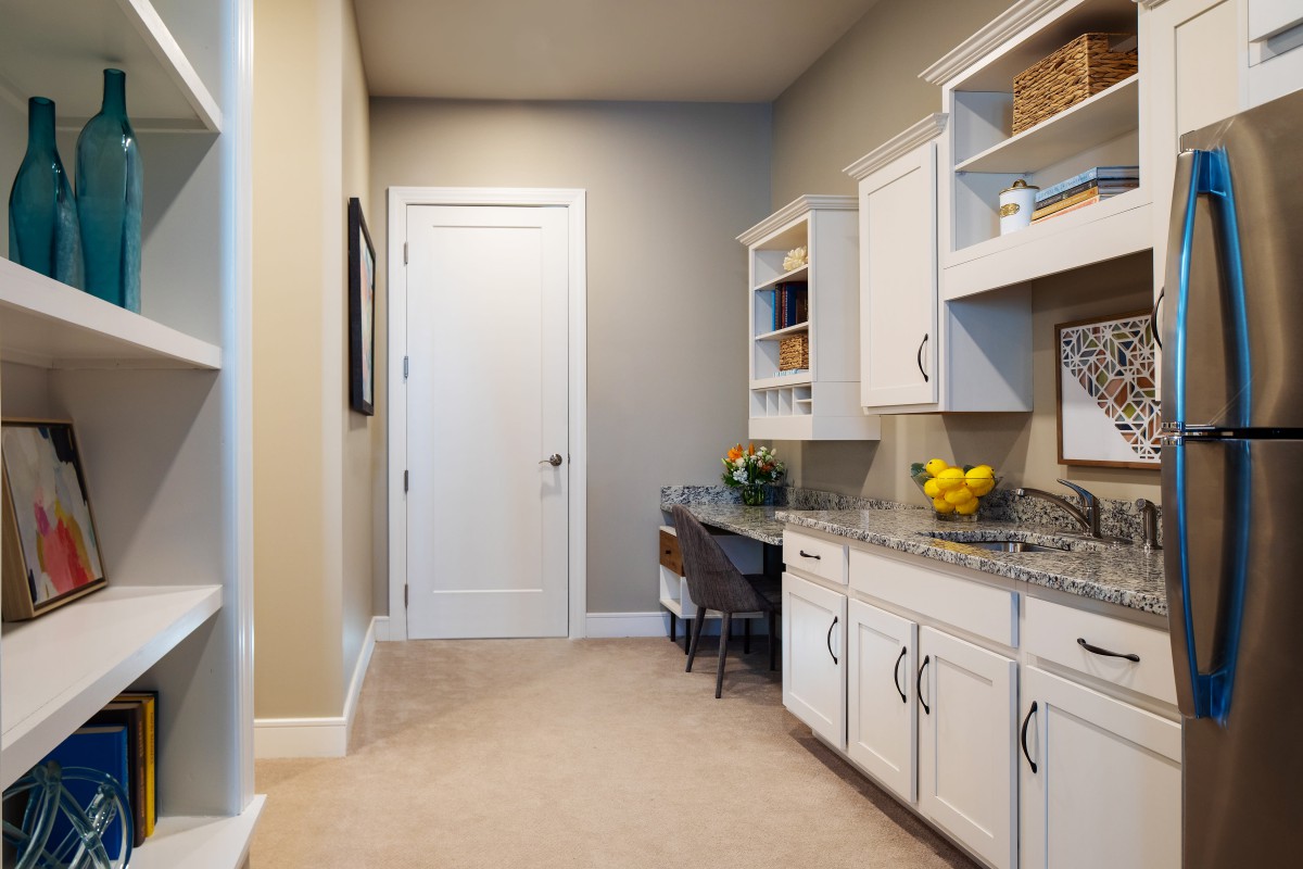 A modern home office space with built-in cabinets and a sleek desk area.