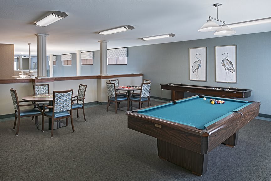 A recreation room featuring a pool table and seating area.
