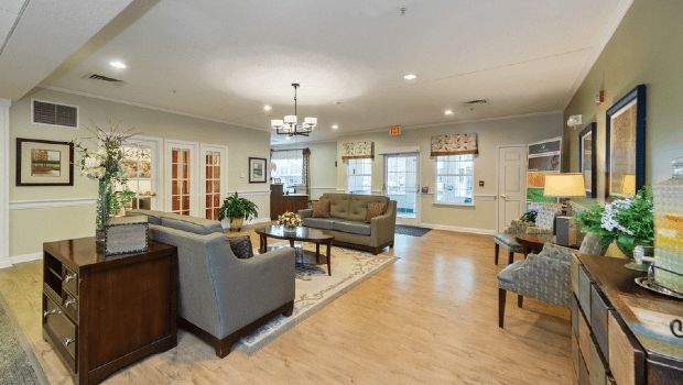 A spacious and inviting living room with comfortable sofas, a central coffee table, and elegant lighting.