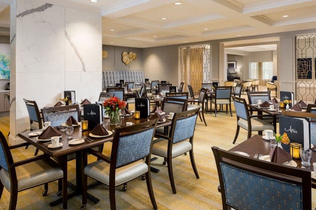An elegant restaurant dining area with neatly arranged tables and chairs.