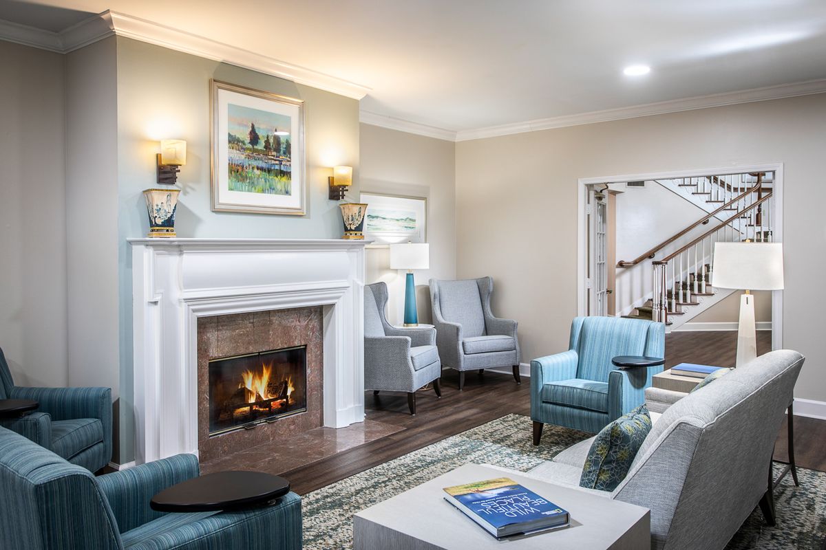 A cozy living room with a fireplace, modern furniture, and elegant decor.