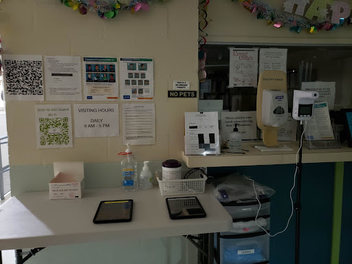 A healthcare workstation with tablets, medical supplies, and informational posters.