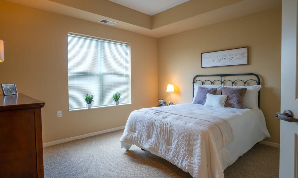A cozy bedroom with a neatly made bed, soft lighting, and minimalist decor.