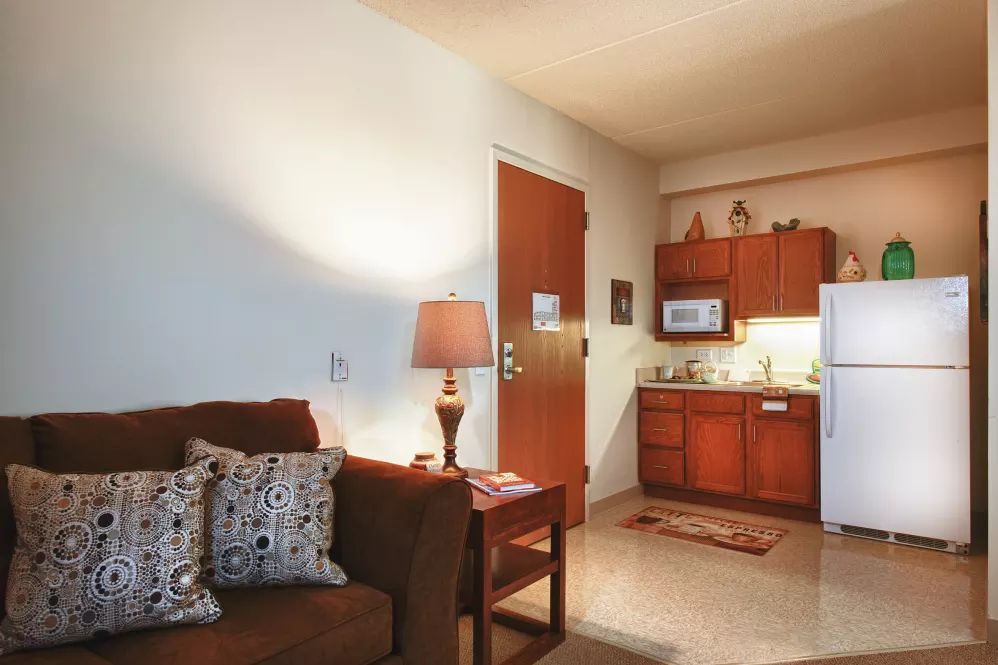 A cozy apartment with a small living area and kitchenette.