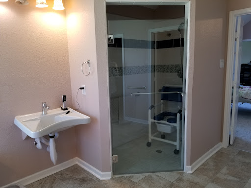A modern bathroom featuring a glass door shower and accessible design elements.