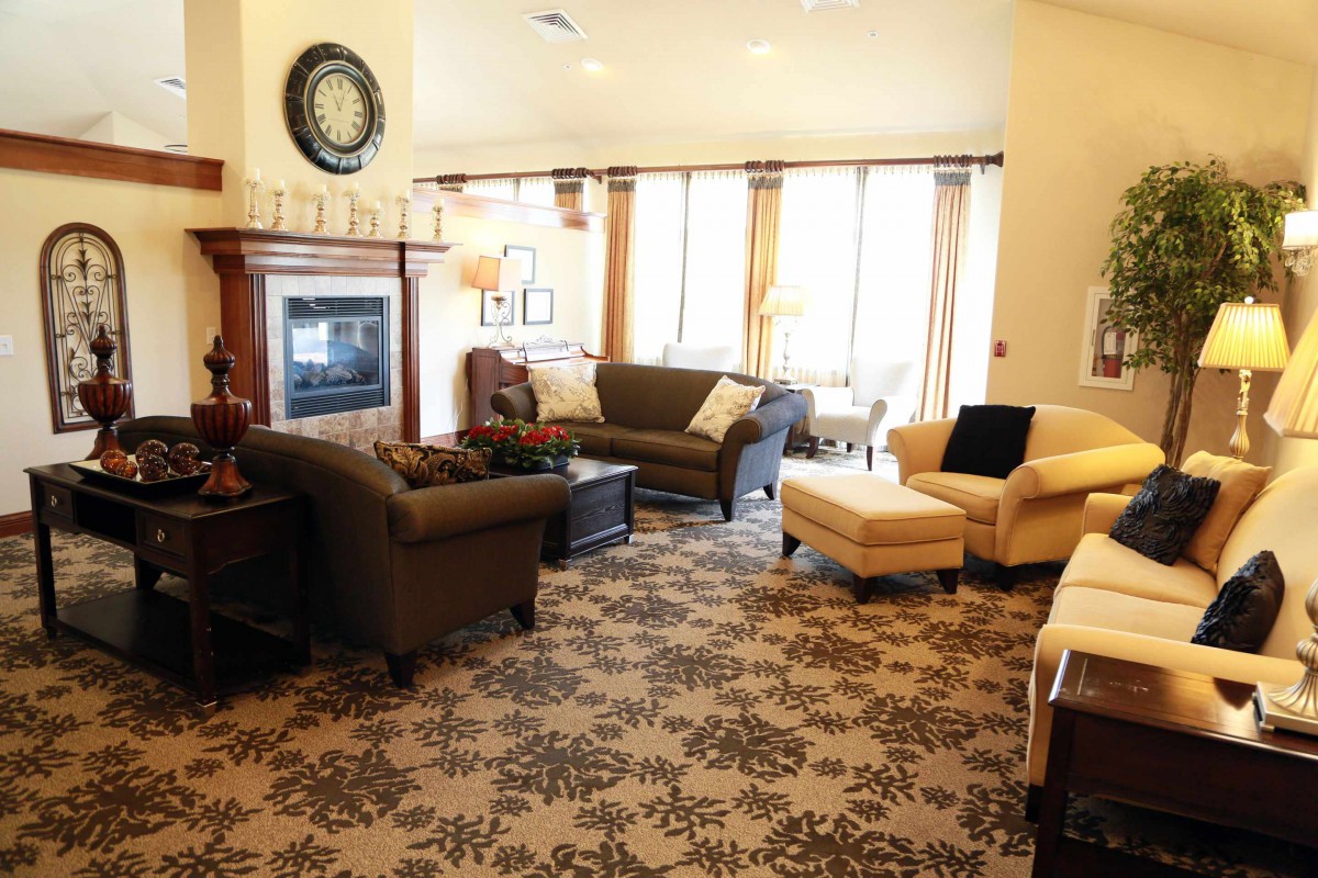 A cozy living room with comfortable seating, a fireplace, and elegant decor.