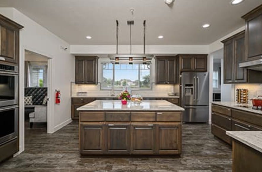 A modern kitchen with a central island and stainless steel appliances.