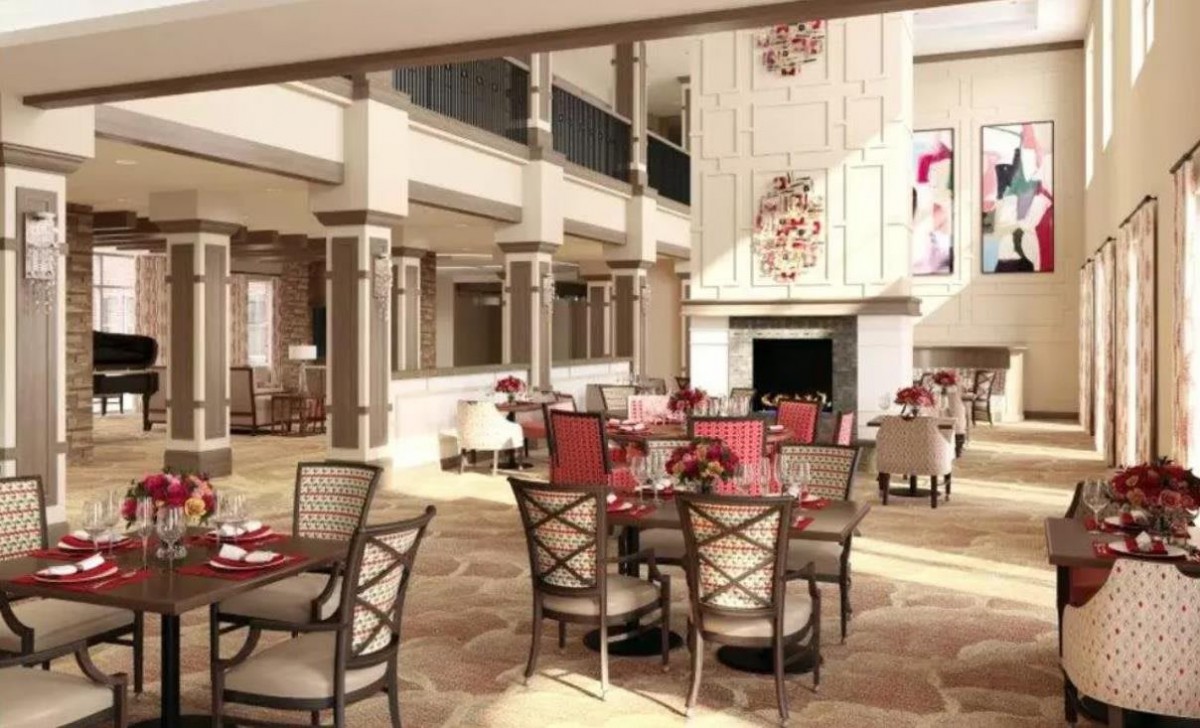 An elegant and spacious restaurant interior with modern furniture and chandeliers, creating an inviting dining atmosphere.