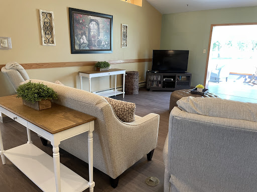 A cozy living room featuring comfortable seating, a television, and decorative elements.