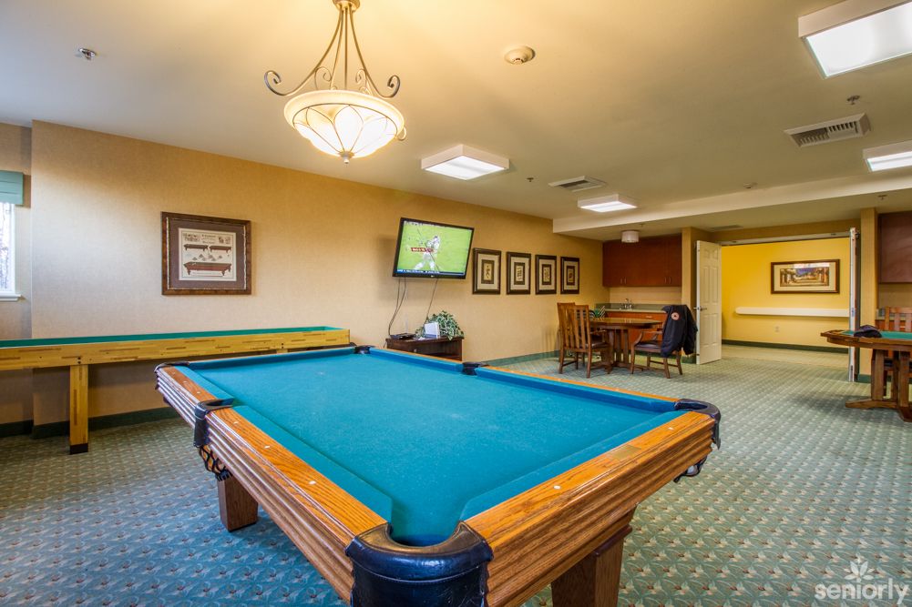 A recreation room featuring pool tables and a television.