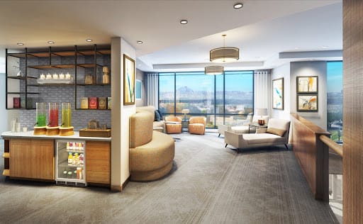 A modern living room with ample natural light and city views.