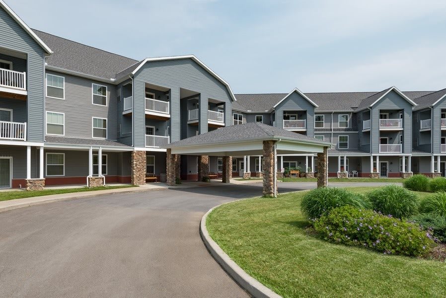 A modern residential apartment complex with an inviting entrance and landscaped surroundings.