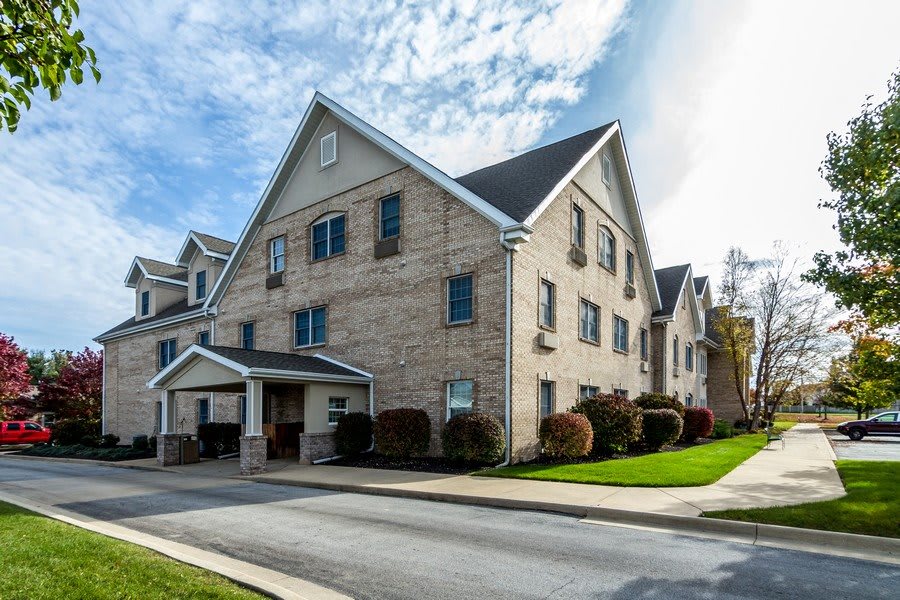 A suburban residential building with a gabled roof and brick exterior.