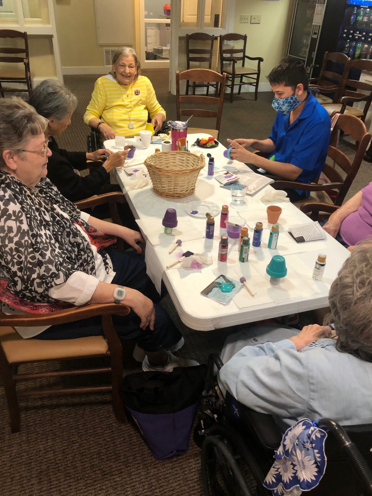 A group of seniors engaging in a crafting activity together at a table.