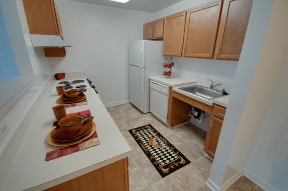 A compact kitchen with wooden cabinets and modern appliances.
