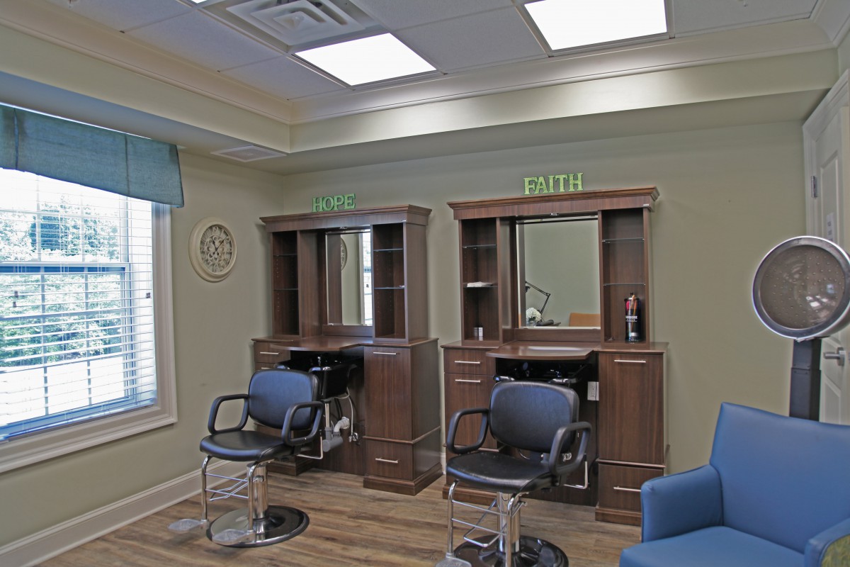 A hair salon interior with chairs and mirrors.