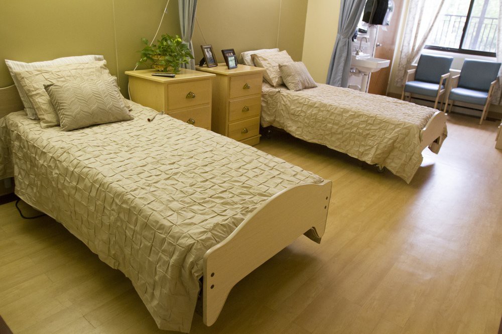 A cozy bedroom with two single beds and a dresser.