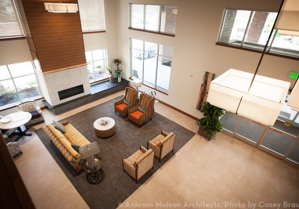 A modern living room with ample seating and large windows.
