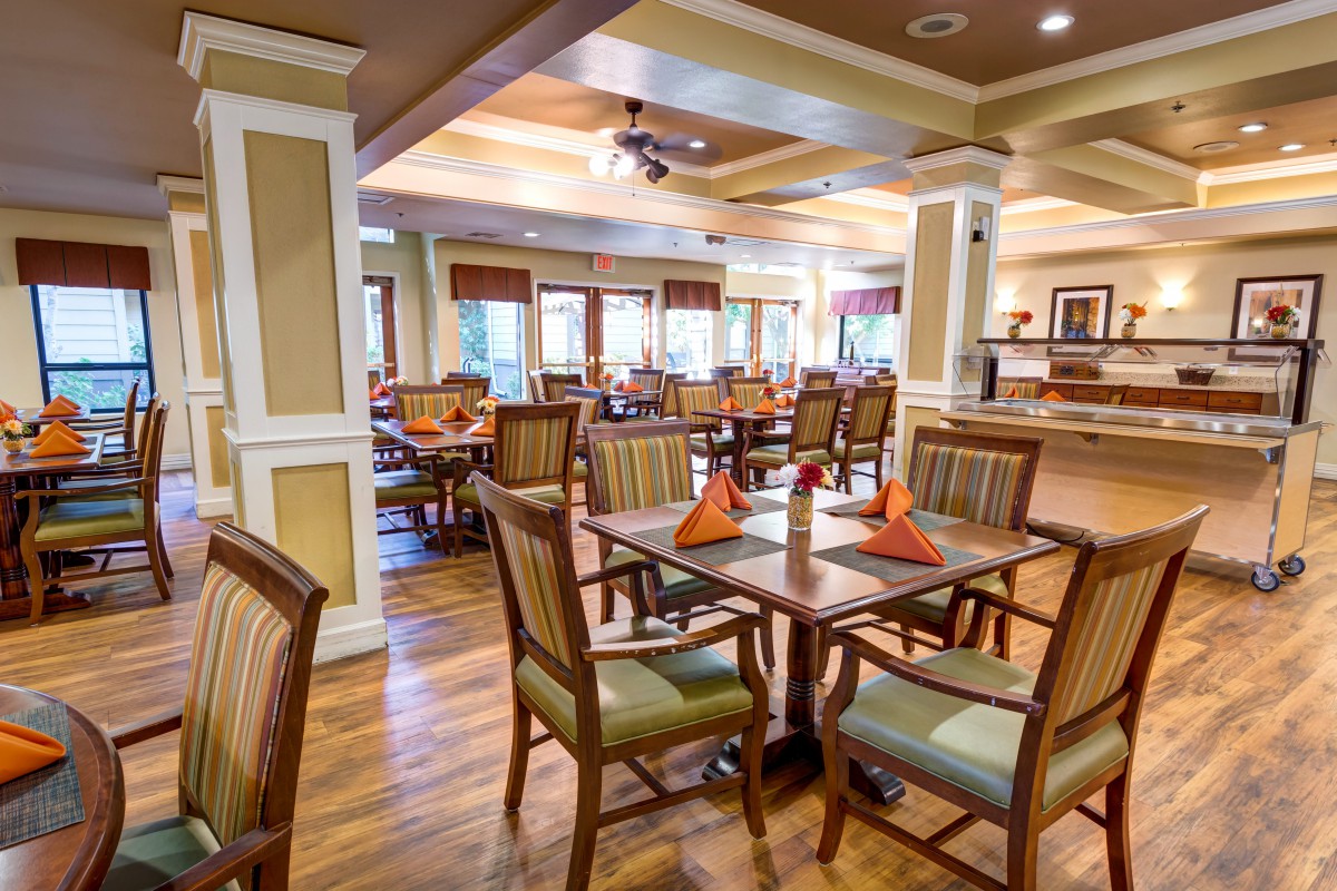 A cozy and well-decorated restaurant dining area with neatly arranged tables and chairs.