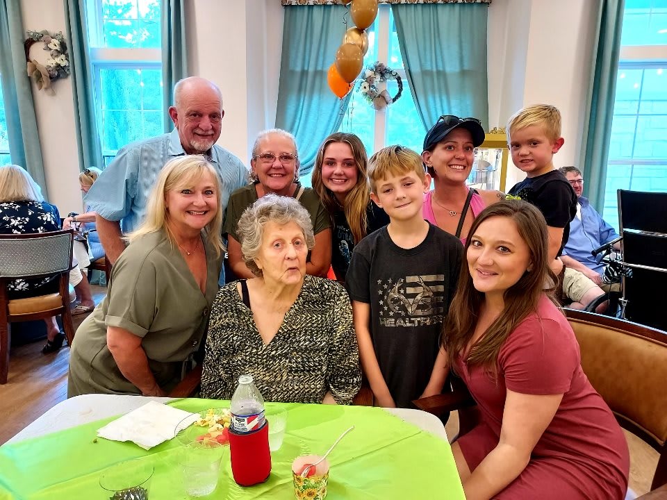 A family gathered together for a group photo during a celebration.