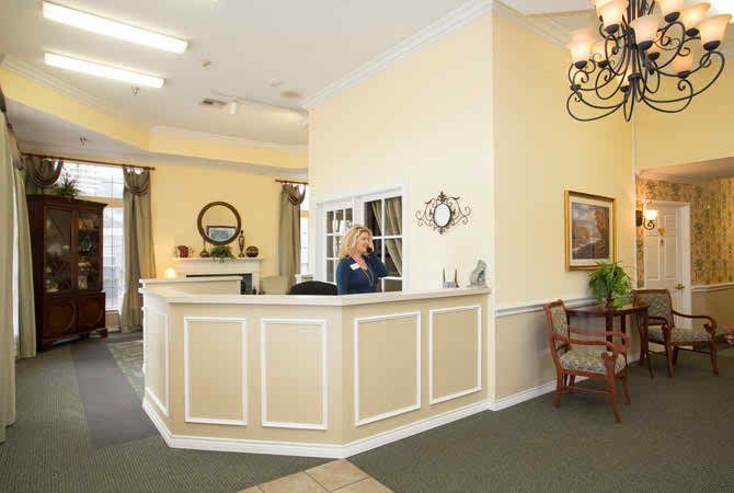 A well-lit reception area with a front desk and elegant decor.