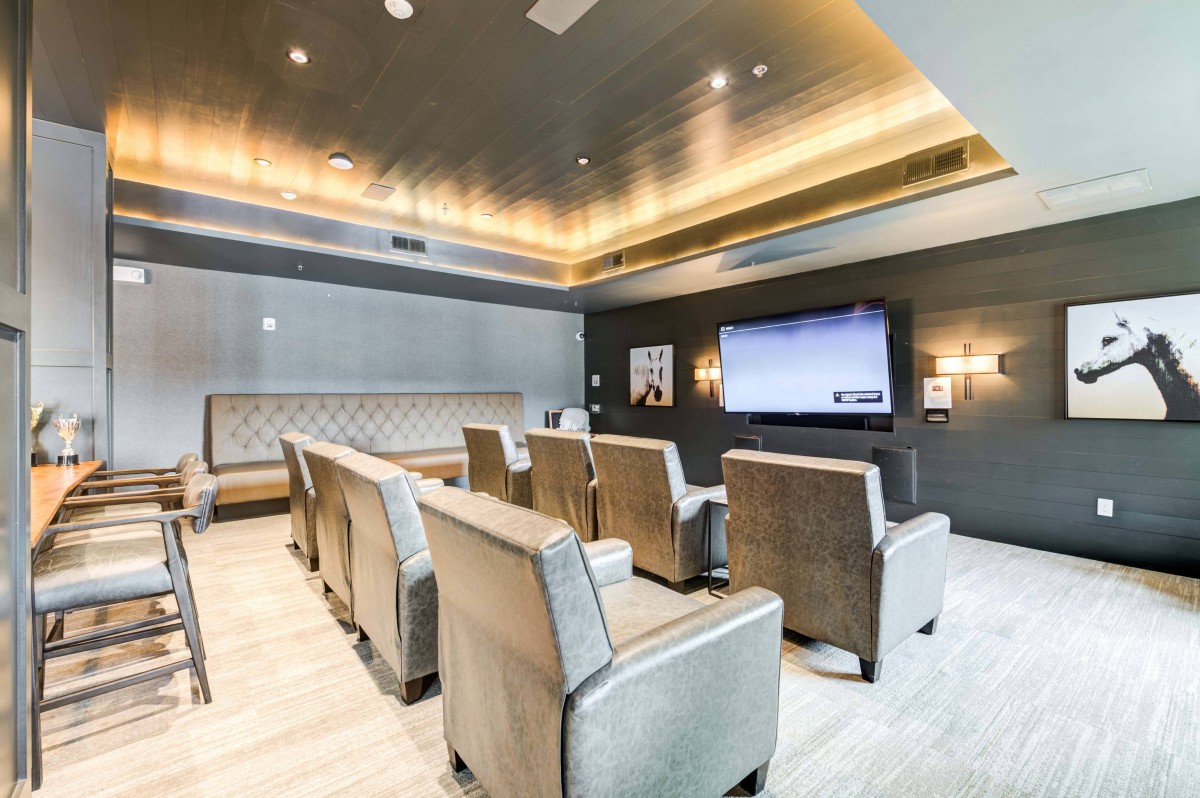A modern home theater with comfortable seating and a large screen.