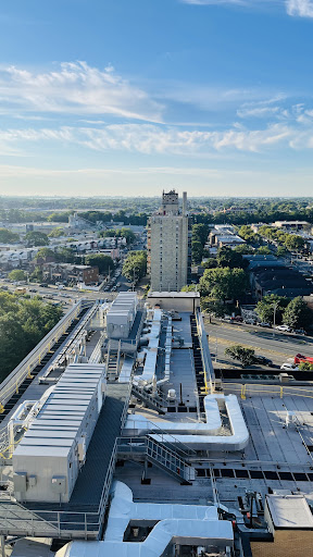 A panoramic view of a city showcasing modern buildings and infrastructure under a clear blue sky.