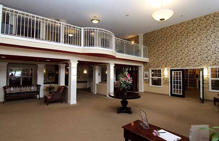 Spacious lobby with elegant decor and balcony view.