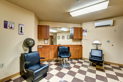 A cozy barbershop interior featuring classic chairs and a checkered floor.