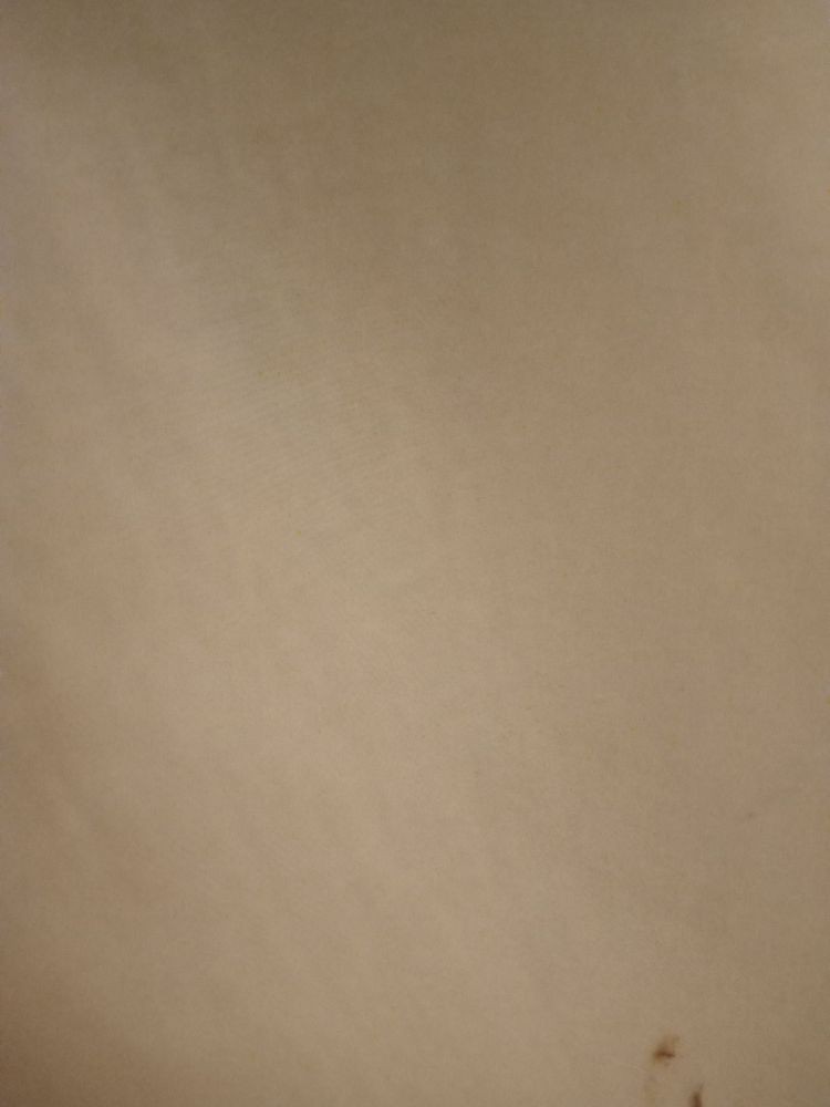 A close-up view of a beige textured surface.
