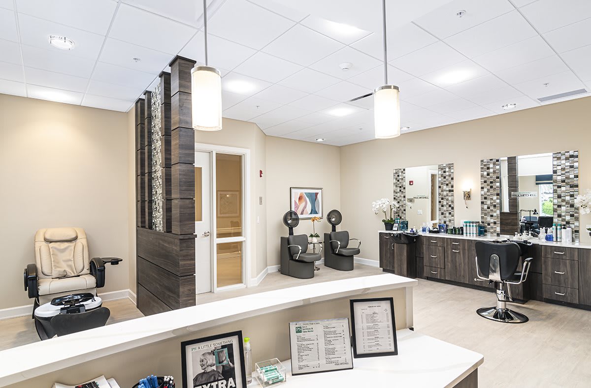 Modern hair salon interior with a waiting area and styling stations.