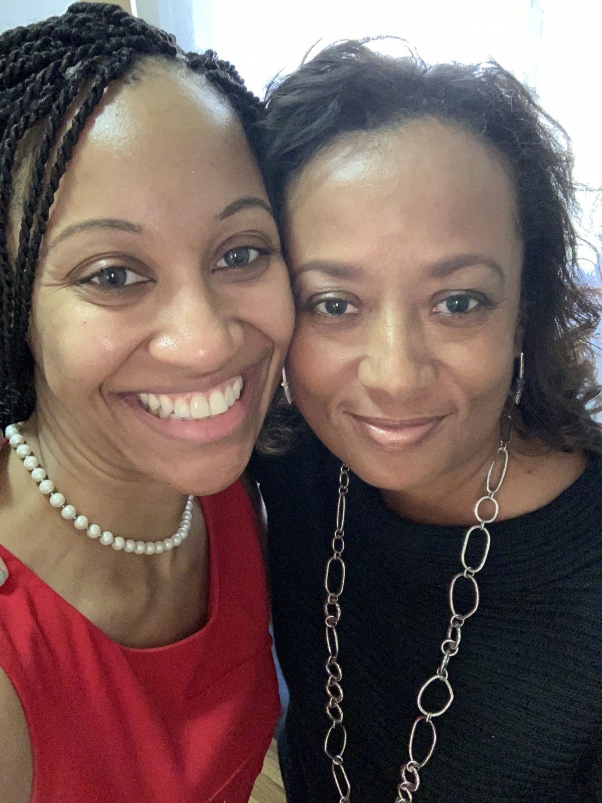 Two women smiling for a selfie.