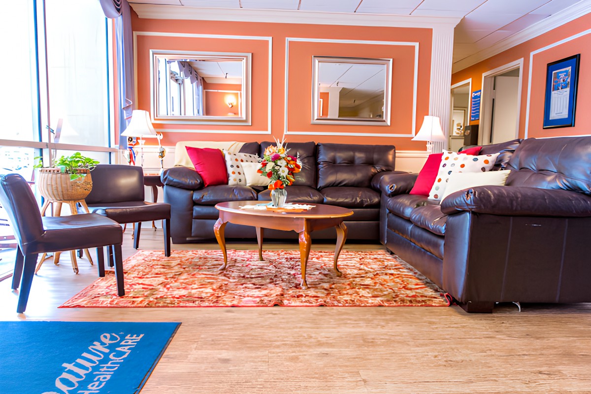 A cozy living room with comfortable sofas, a wooden coffee table, and decorative cushions.