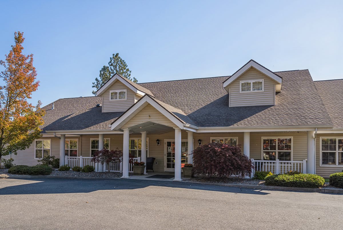 A single-story residential building with a prominent front porch and triangular roof design.