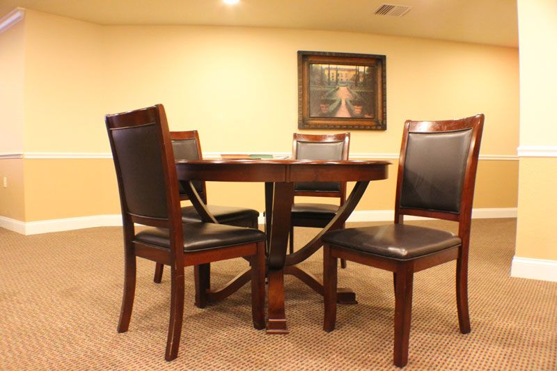 A cozy dining area with a wooden table and four chairs.
