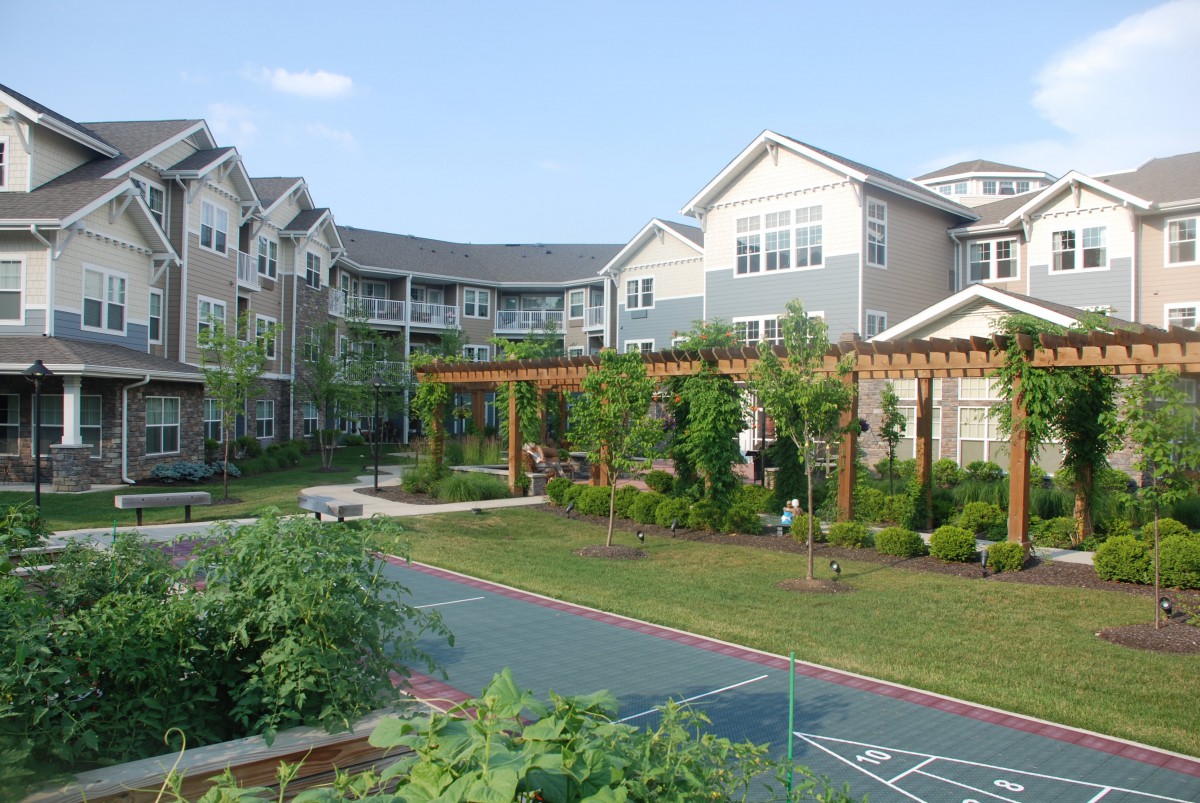 A landscaped garden area surrounded by apartment buildings.