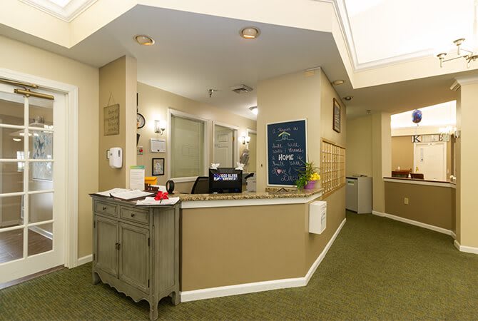 A reception area with a desk and office decor.
