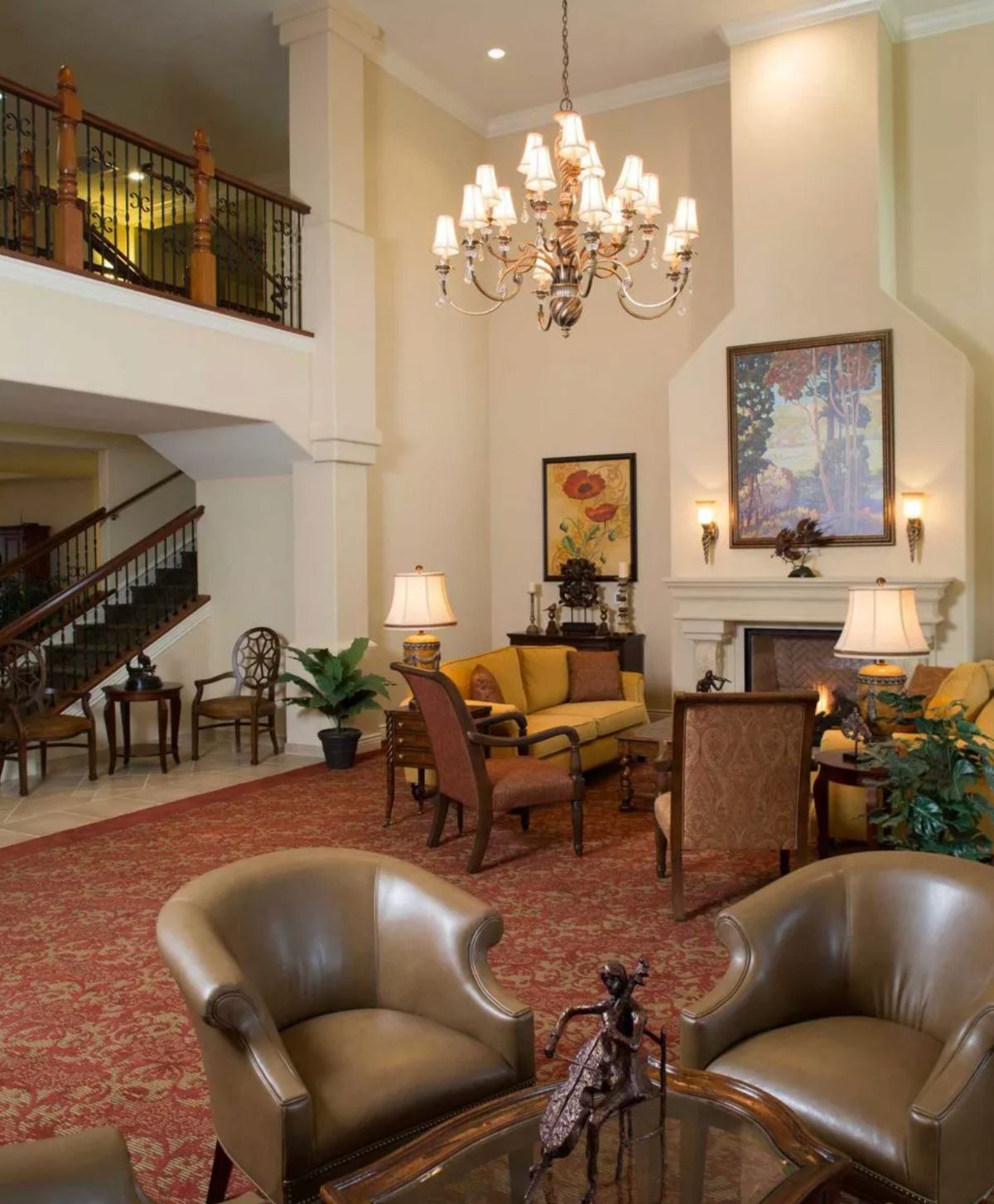 A cozy hotel lobby with elegant seating and a grand chandelier.