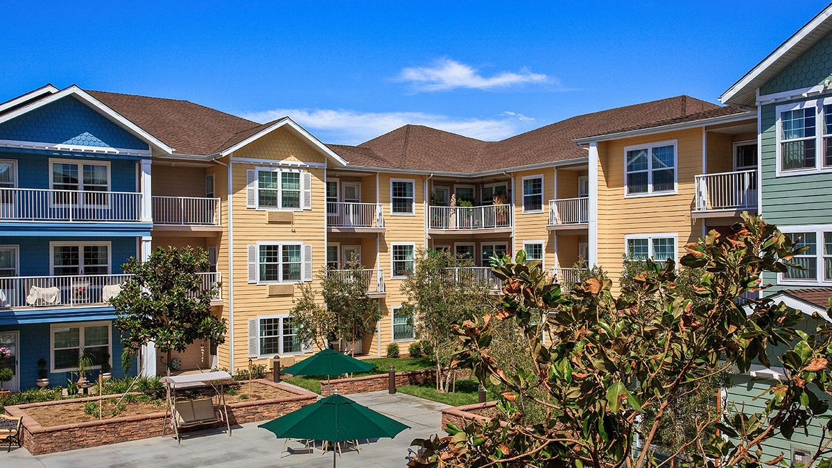 A modern apartment building with a landscaped courtyard.