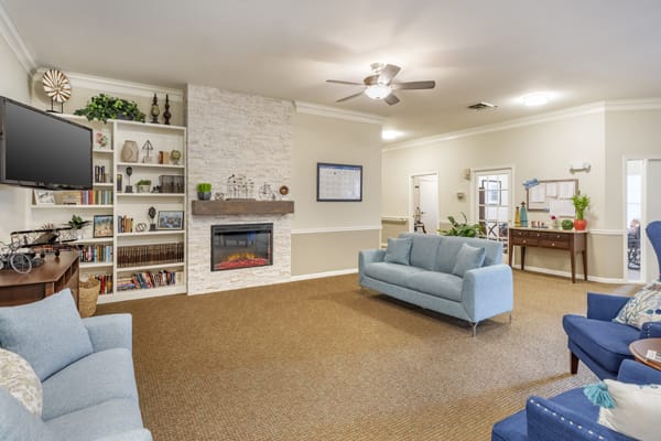 Spacious living room with a cozy fireplace and modern decor.