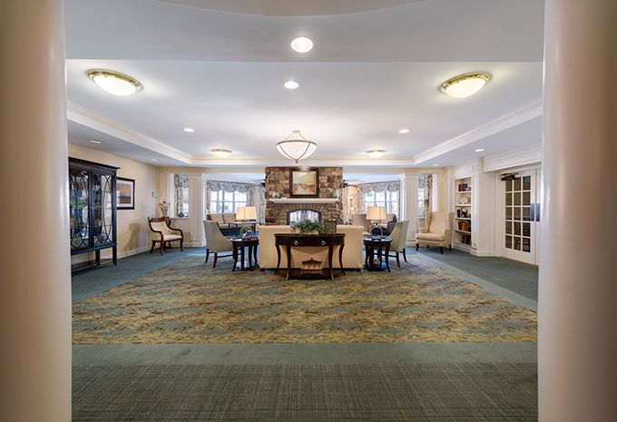 A spacious and elegantly furnished lobby with cozy seating and warm lighting.