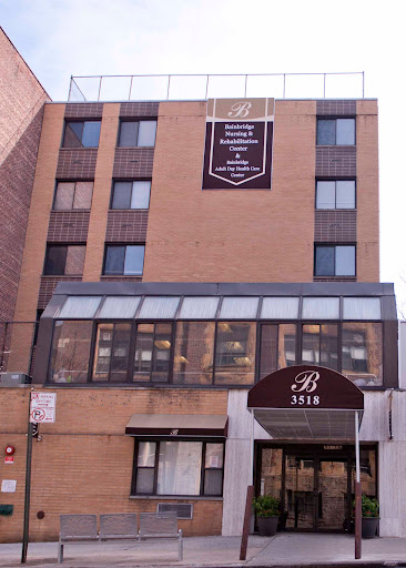 Exterior view of a multi-story residential building with a prominent entrance.