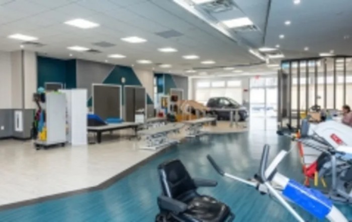 A modern gym interior with various exercise equipment.